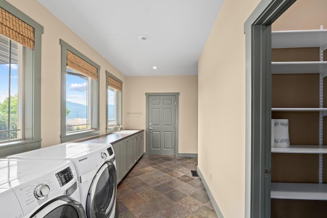 washroom with separate washer and dryer, sink, and cabinets