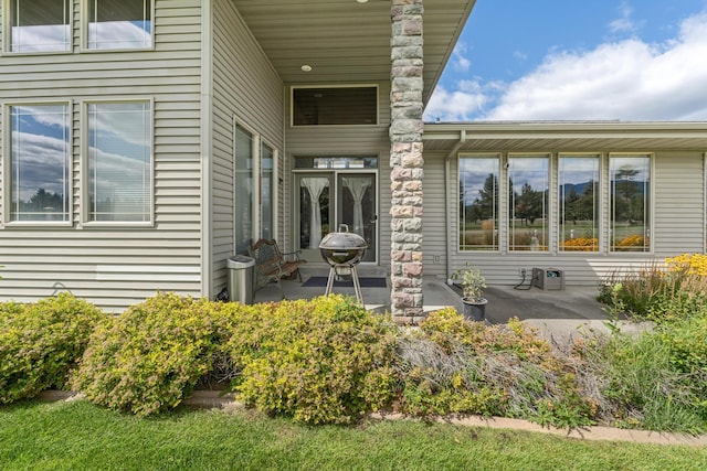 entrance to property featuring a patio