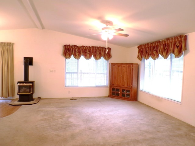 17 Crestview Dr, Kettle Falls, WA 99141 - unfurnished living room featuring a ceiling fan, plenty of natural light, a wood stove, and carpet floors