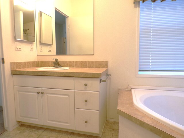 bathroom with tile patterned floors and vanity