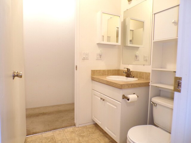 bathroom with toilet and vanity