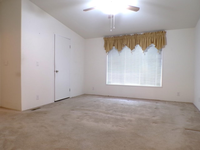 unfurnished room featuring ceiling fan, light colored carpet, and lofted ceiling