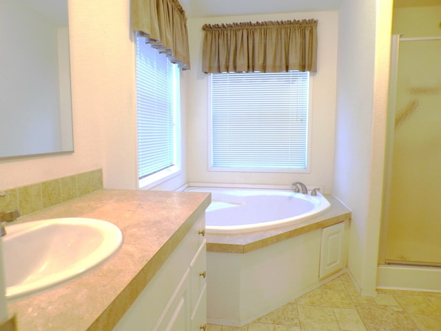 bathroom featuring vanity, tile patterned floors, and shower with separate bathtub