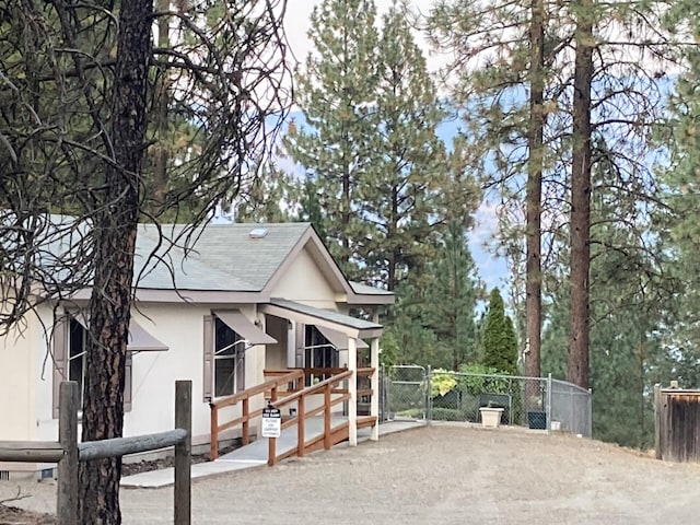 17 Crestview Dr, Kettle Falls, WA 99141 - view of property exterior featuring stucco siding and a gate