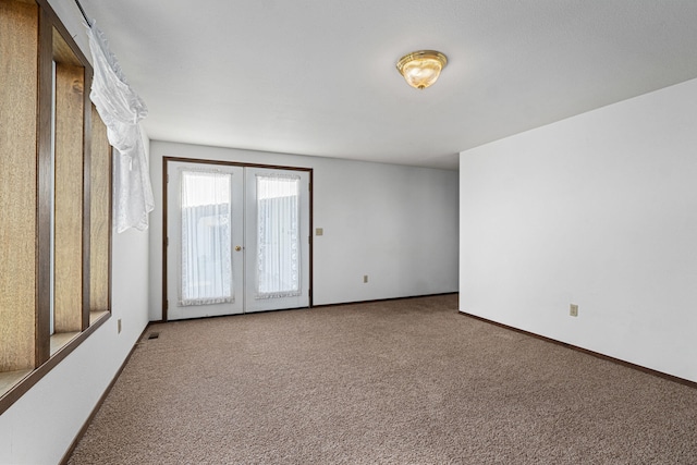 505 W Court Ave, Chewelah, WA 99109 - spare room with carpet floors, french doors, and baseboards