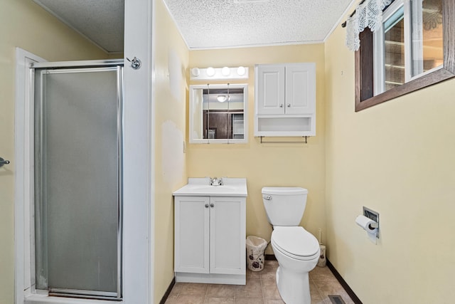 505 W Court Ave, Chewelah, WA 99109 - bathroom featuring a shower stall, toilet, vanity, a textured ceiling, and baseboards