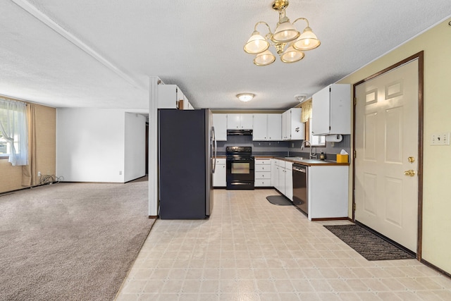 505 W Court Ave, Chewelah, WA 99109 - kitchen with appliances with stainless steel finishes, under cabinet range hood, a chandelier, white cabinets, and a sink