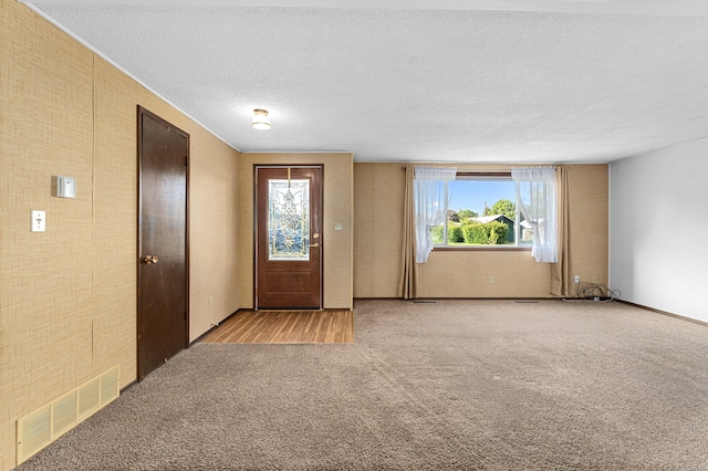 505 W Court Ave, Chewelah, WA 99109 - foyer featuring light carpet, healthy amount of natural light, and a textured ceiling