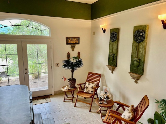 entryway with light tile patterned floors, a wealth of natural light, and french doors