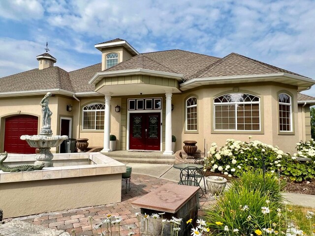 rear view of property with french doors and a patio