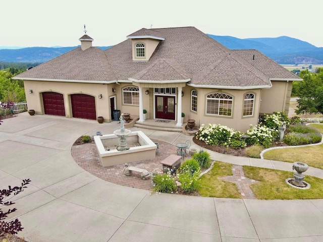 view of front of house with a mountain view and french doors