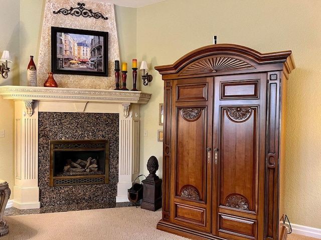 interior space featuring light colored carpet and a high end fireplace