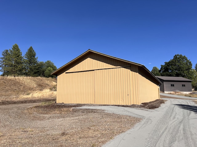 view of home's exterior with an outbuilding