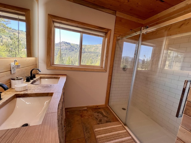 3705 Hope Way, Kettle Falls, WA 99141 - bathroom featuring a shower stall, double vanity, and baseboards