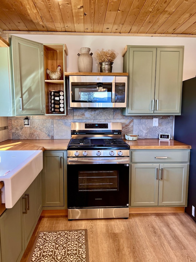 3705 Hope Way, Kettle Falls, WA 99141 - kitchen with stainless steel appliances, wood ceiling, light wood-style floors, tasteful backsplash, and a sink