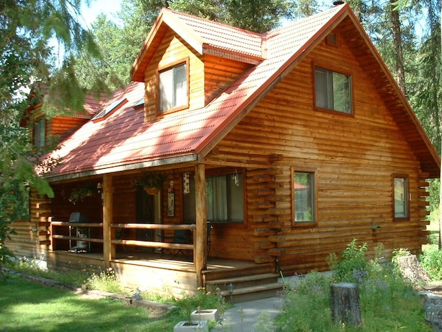 rear view of property featuring a porch