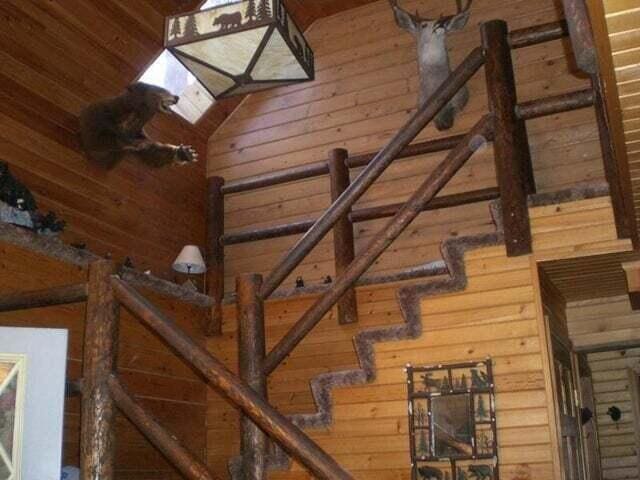 stairs featuring vaulted ceiling and wooden walls