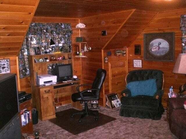 carpeted office with wood ceiling, vaulted ceiling, and wooden walls