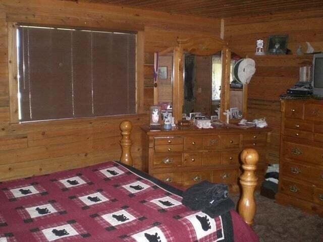 bedroom featuring wood walls