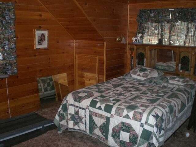 bedroom featuring wood walls, wood ceiling, and vaulted ceiling