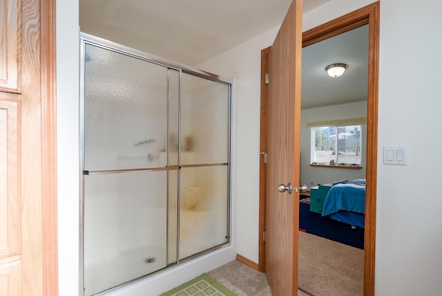 bathroom with a shower with door