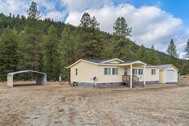 manufactured / mobile home featuring a garage and a carport