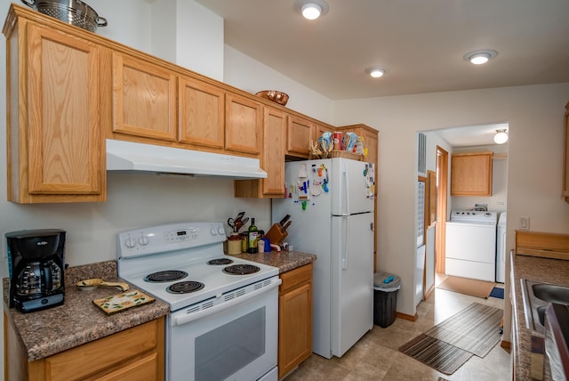 kitchen featuring washing machine and dryer and white appliances