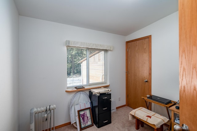 office area with light colored carpet, radiator heating unit, and vaulted ceiling