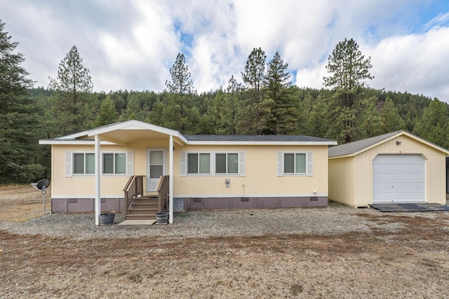 manufactured / mobile home with a garage and an outdoor structure