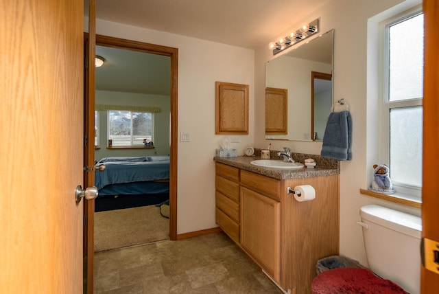 bathroom with toilet and vanity