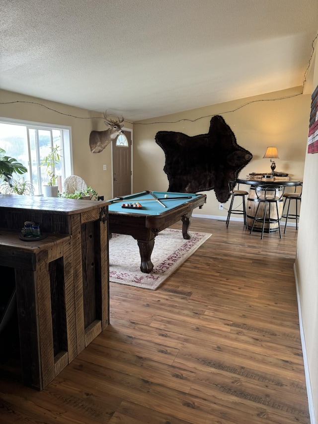 rec room featuring billiards, dark hardwood / wood-style floors, and a textured ceiling