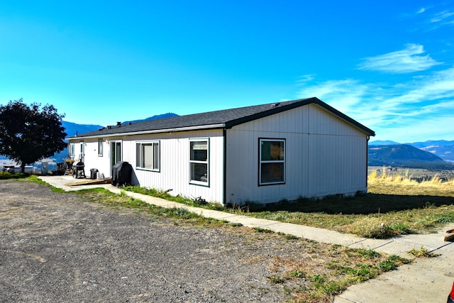 view of side of home with a mountain view