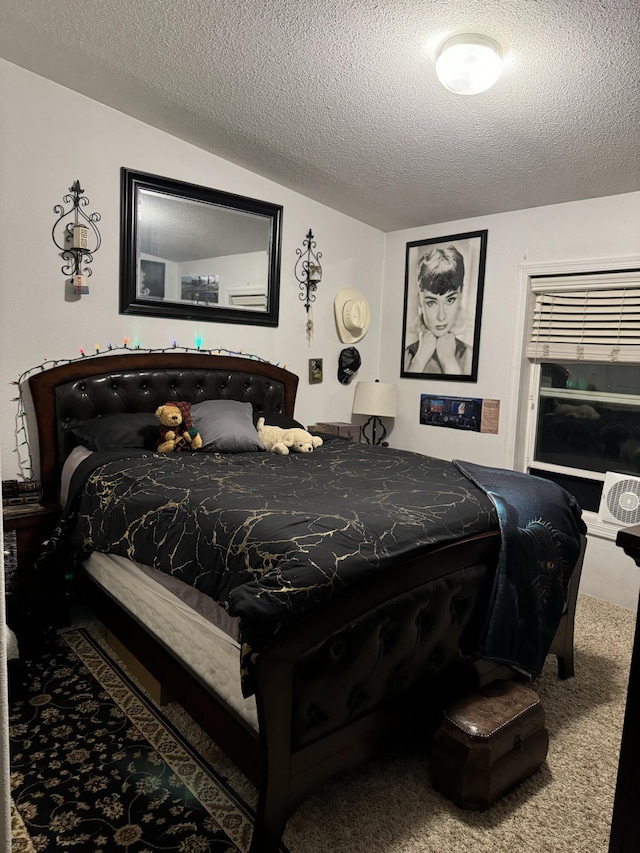 bedroom with lofted ceiling, carpet, and a textured ceiling