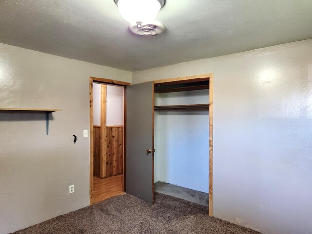 unfurnished bedroom featuring a closet and carpet flooring