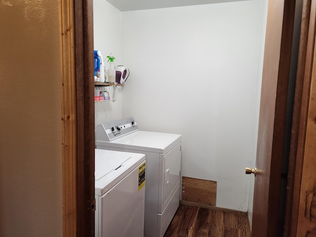 clothes washing area with dark wood-type flooring and washer and clothes dryer