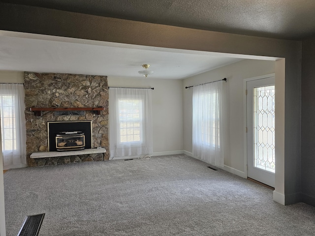 unfurnished living room featuring a textured ceiling and carpet floors