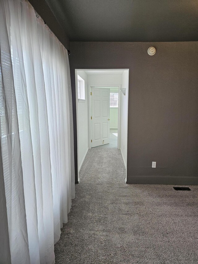 hallway featuring carpet