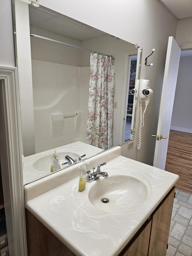 bathroom with curtained shower and vanity