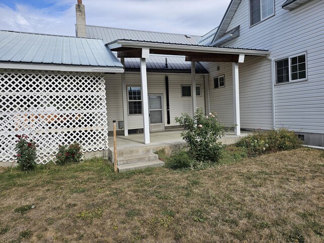 exterior space with covered porch and a yard