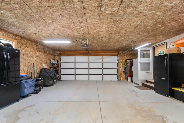garage with freestanding refrigerator and a garage door opener