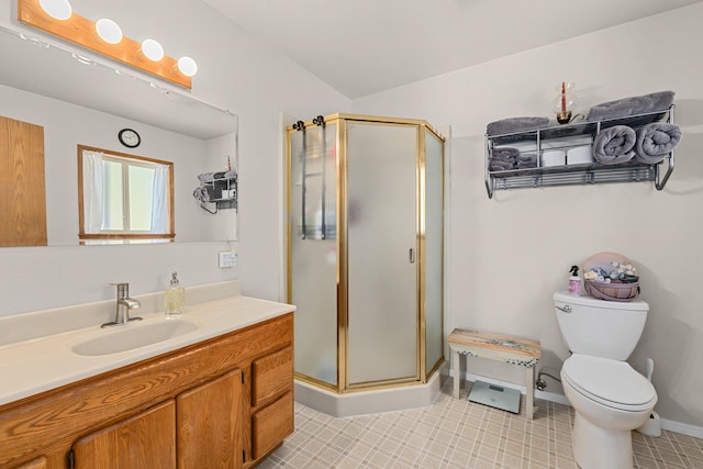 bathroom featuring a shower stall, vanity, baseboards, and toilet