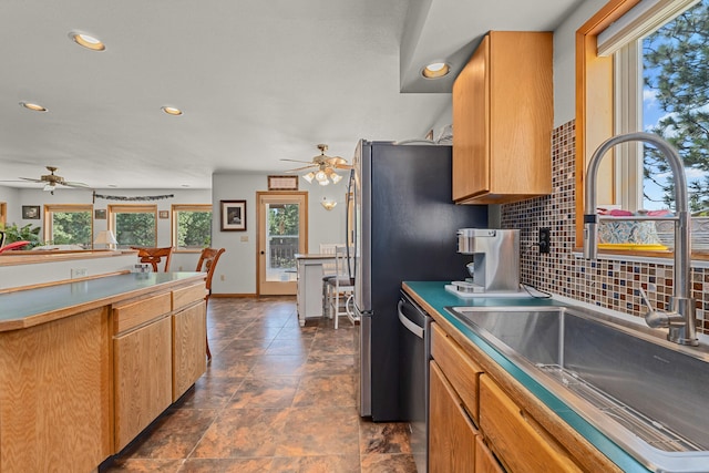kitchen featuring a healthy amount of sunlight, a sink, and ceiling fan