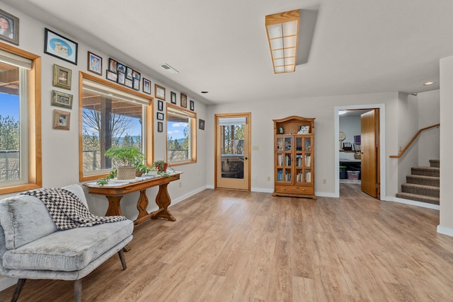sitting room with visible vents, recessed lighting, stairway, wood finished floors, and baseboards