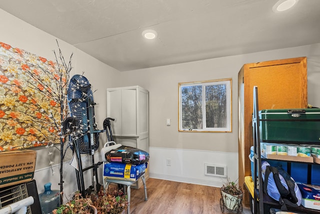 game room with wood finished floors, baseboards, and visible vents