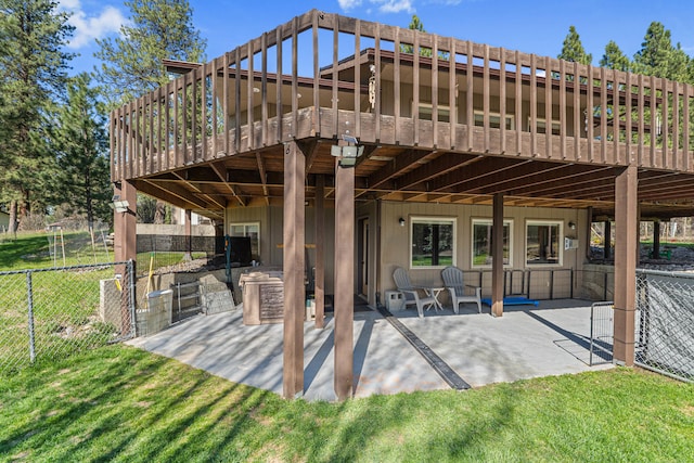 view of patio with a deck and fence