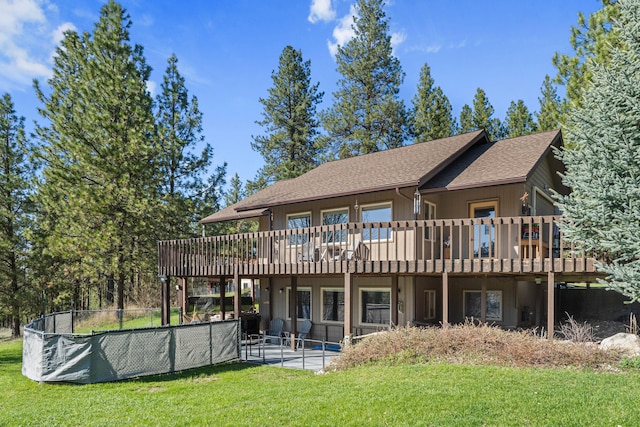 rear view of house with a patio area, a deck, and a lawn