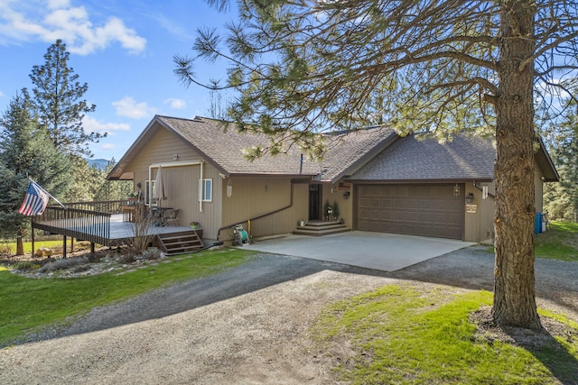 rustic home featuring dirt driveway, a deck, a garage, and roof with shingles