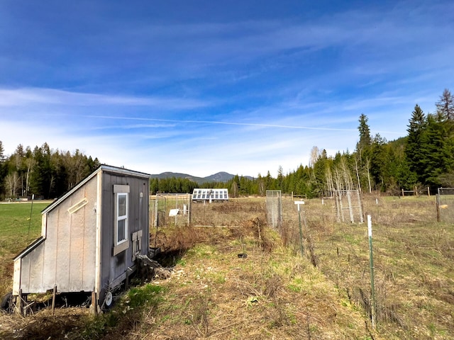 view of yard featuring fence and a mountain view