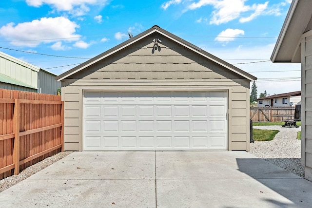 detached garage featuring fence
