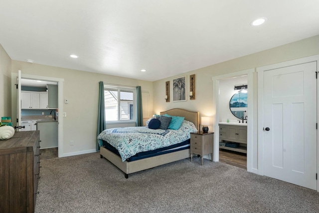 bedroom with recessed lighting, carpet floors, baseboards, and a sink